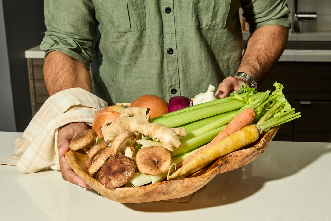 Man holding a basket of organic vegetables